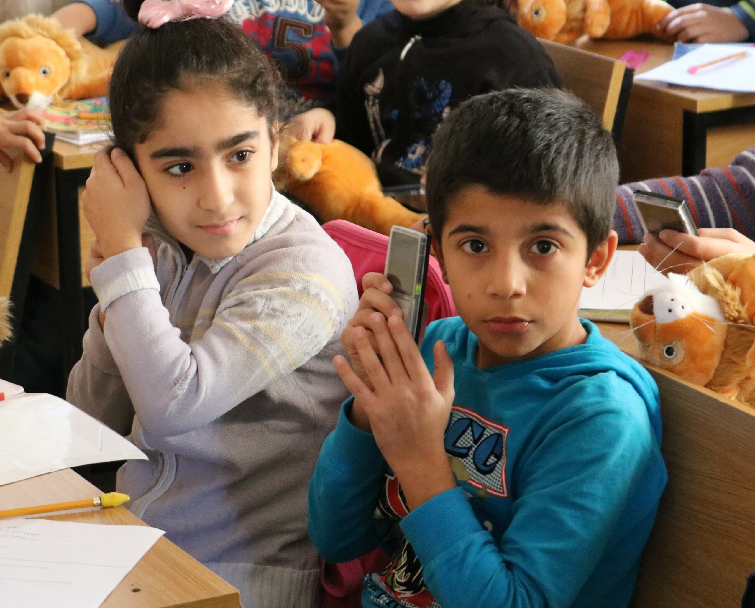 Young boy and girl listening to MegaVoice audio Bibles.